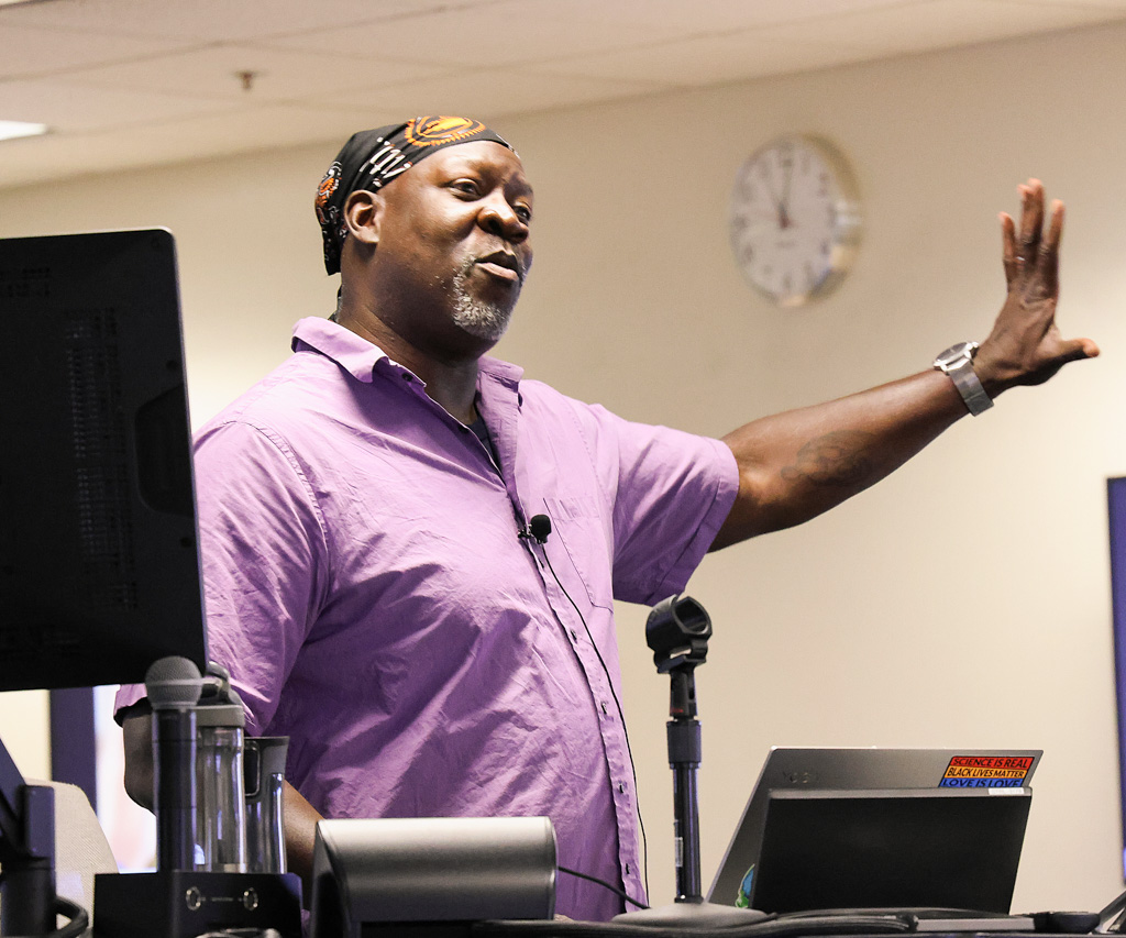 Summer Program instructor presenting at a computer