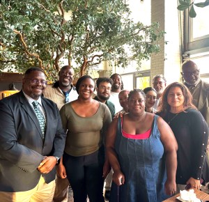 Leaders and participants at the ICPSR Summer Program workshop at Norfolk State University are assembled for a group photo in a bright setting with indoor trees.