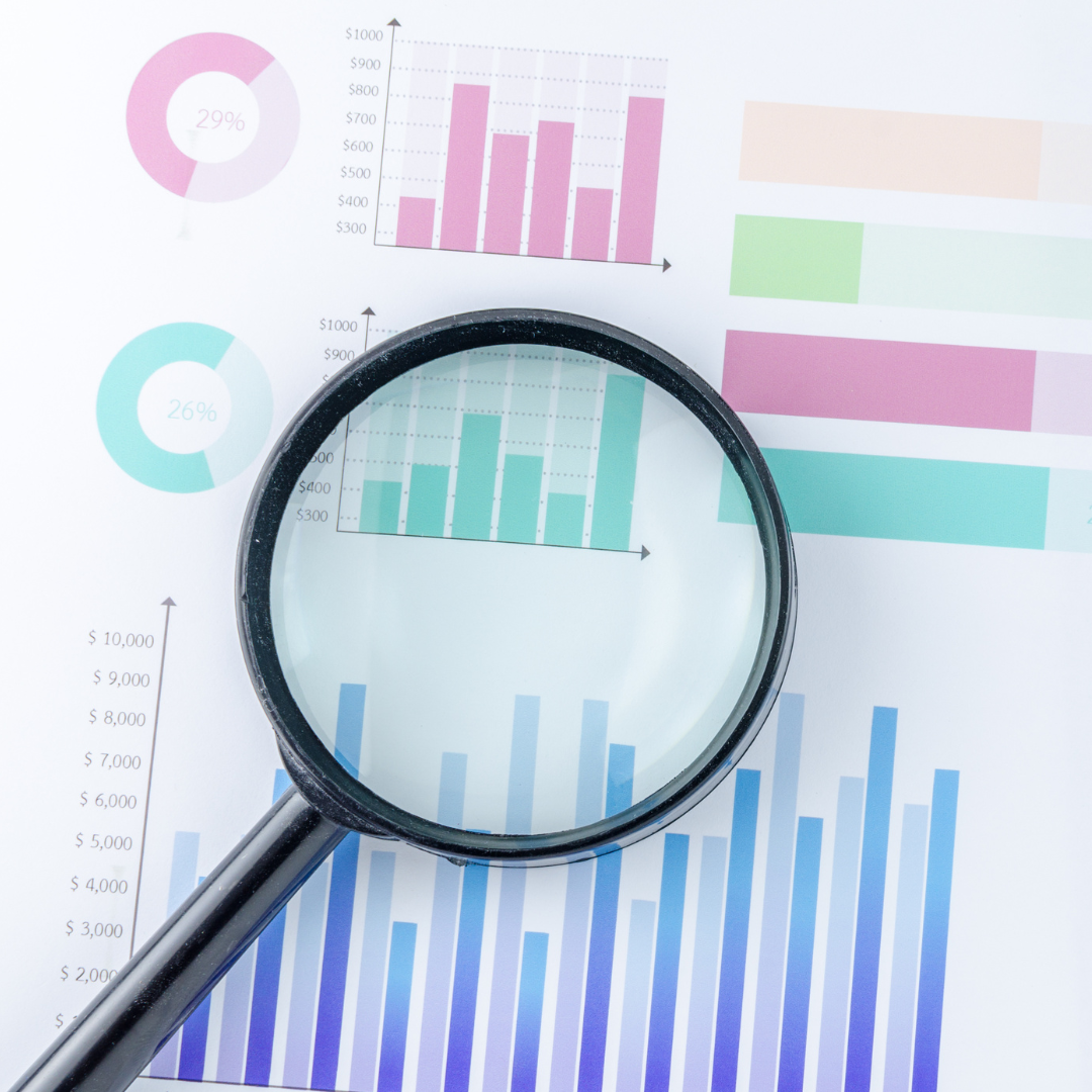 Graphs being examined by a magnifying glass