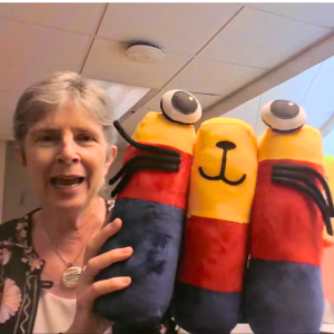 Levenstein is surprised with a Catalog (bar chart) plushie during the celebration on Aug. 11, 2026. Catalog is the companion of ICPSR mascot Data Jeff.